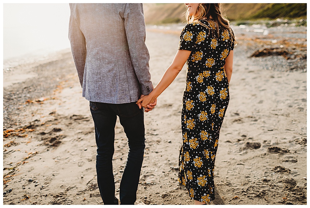 couple walking holding hands on beach