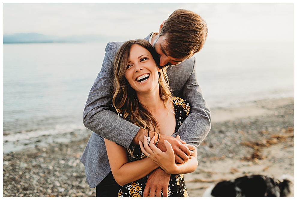 man hugging woman while she laughs