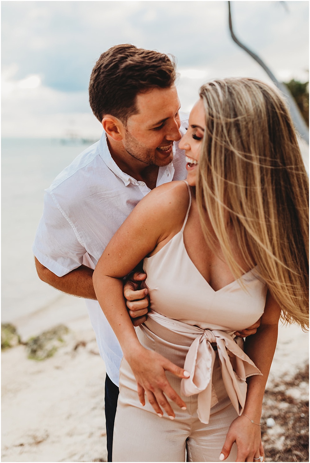 Engagement portraits of couple on beach