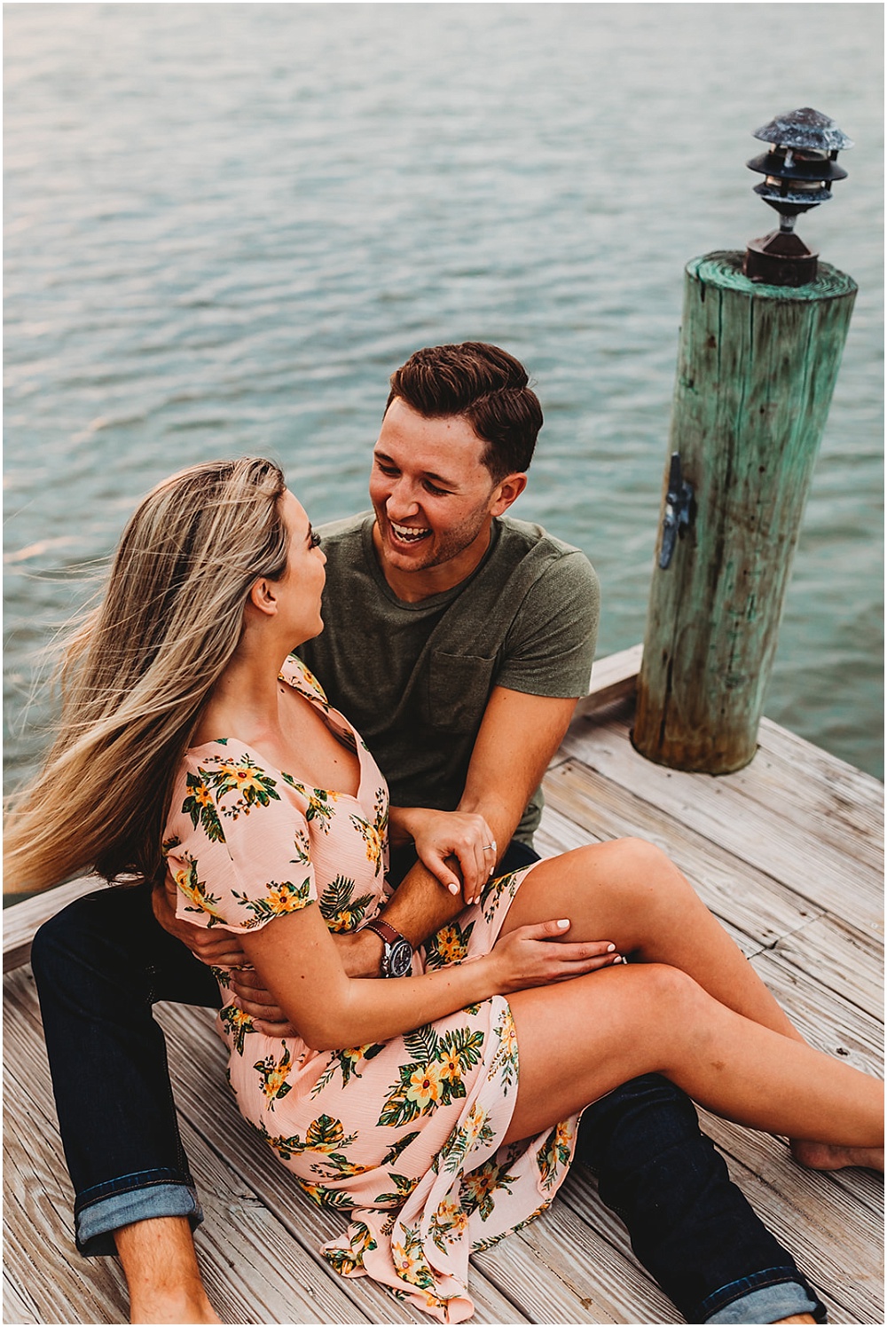 couple shares a laugh on a dock